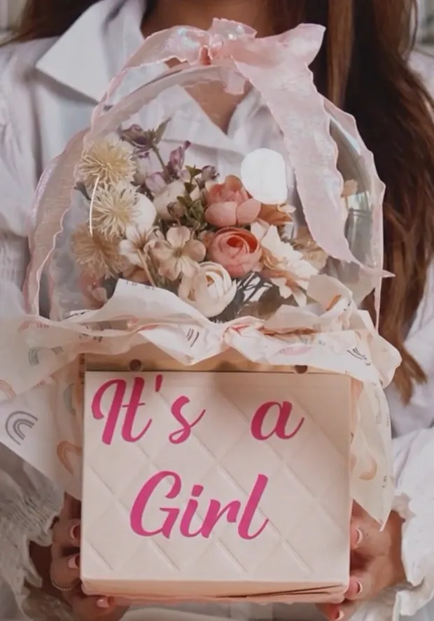 A floral announcement hamper with an It's a Girl box